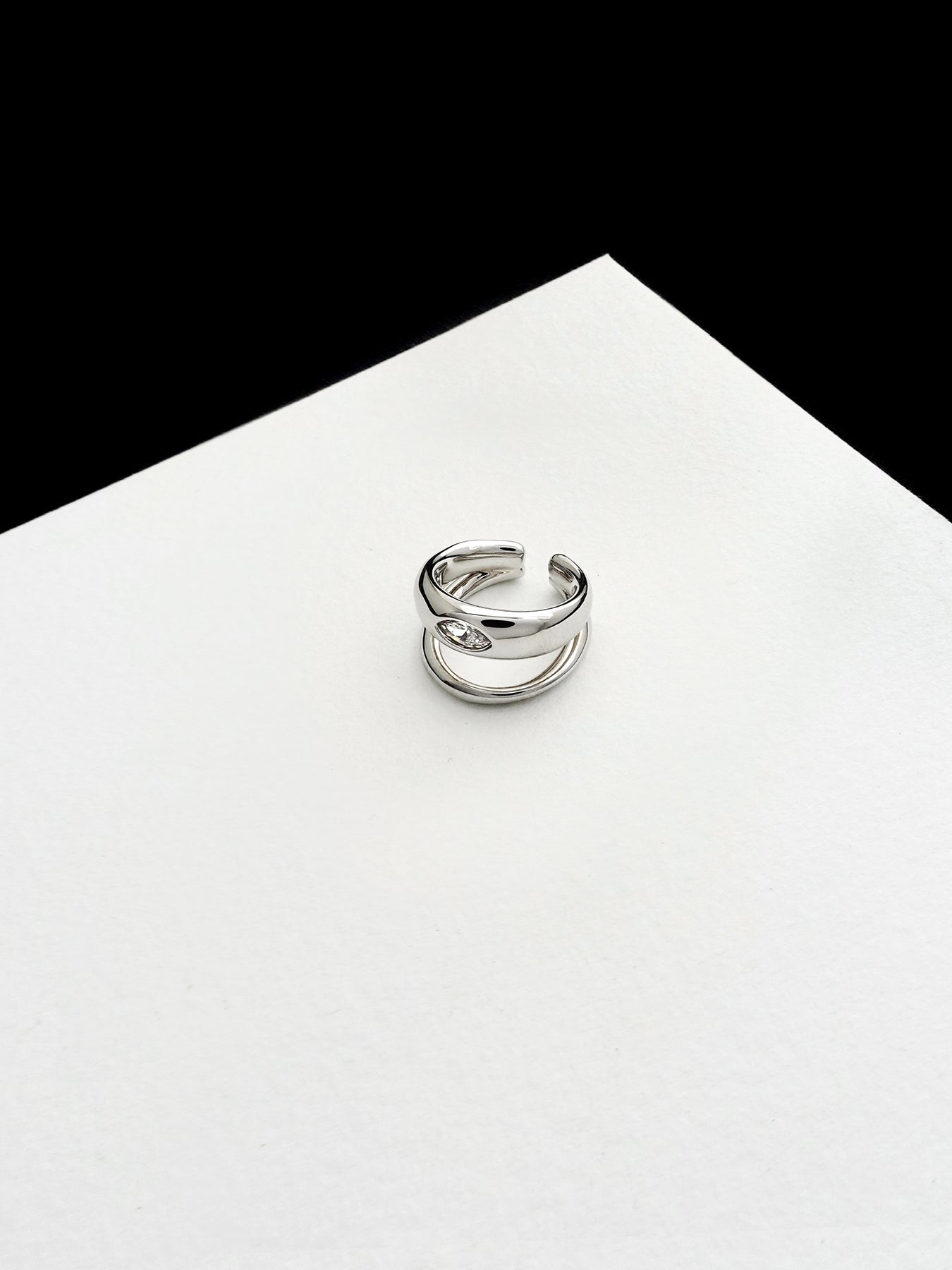 Arcenkelab Classic Ear Cuff in gold and silver finishes. This polished accessory offers versatile style, perfect for layering or solo wear.