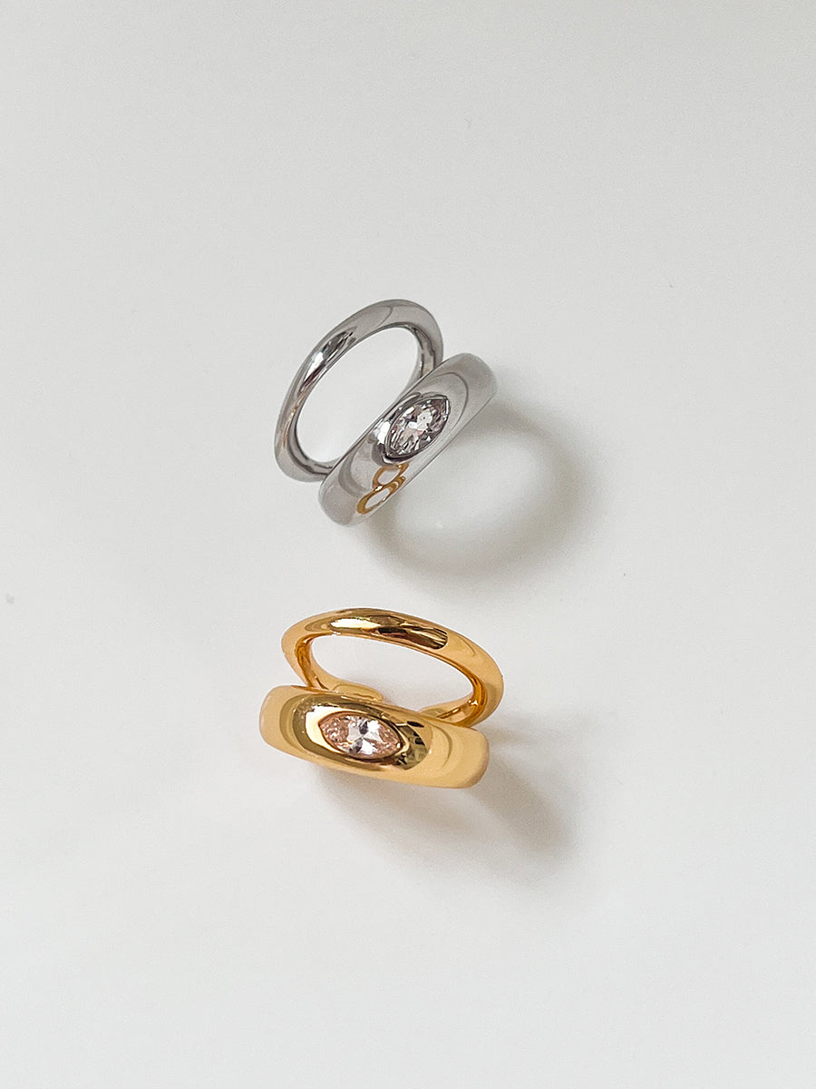 Arcenkelab Classic Ear Cuff in gold and silver finishes. This polished accessory offers versatile style, perfect for layering or solo wear.