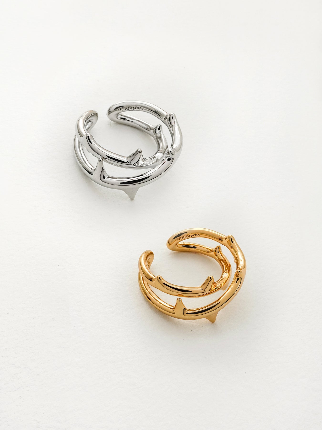 Arcenkelab Rose Thorn Ring in polished gold and silver, featuring thorn-inspired lines for a unisex, versatile accessory that elevates any outfit.