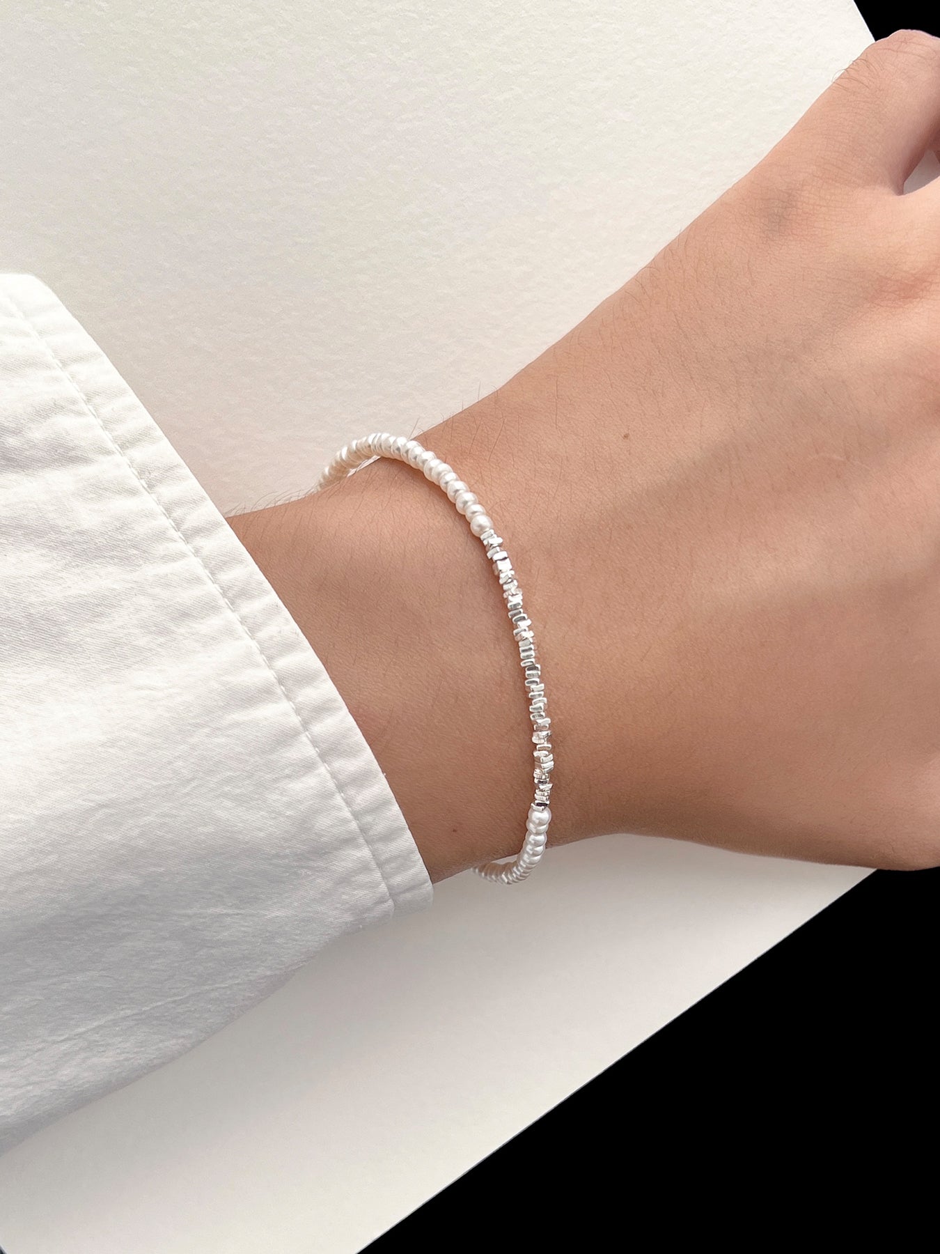 Discover the Arcenkelab Mini Pearl and Silver Necklace—a timeless blend of elegance and simplicity. Perfect for any occasion, this handcrafted piece features delicate pearls and sleek silver, making it versatile for all styles, genders, and ages.