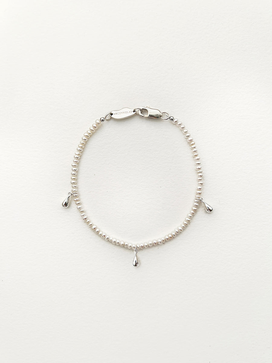 Arcenkelab Tiny Drop Silver Pendant Mini Pearl Bracelet, featuring a minimalist design, unisex style, and a signature 925 silver clasp for versatile elegance.